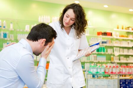 View of an Attractive pharmacist comfort a customer sufferingの写真素材