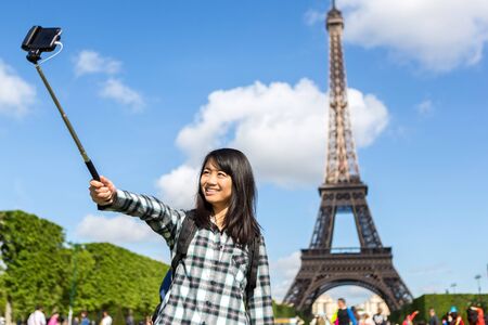 View of a Young attractive asian tourist in Paris taking selfieの写真素材