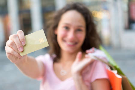 View of a Young attractive woman handling credit card during shoppingの写真素材