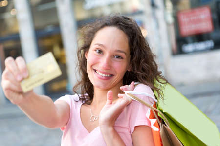 View of a Young attractive woman handling credit card during shoppingの写真素材