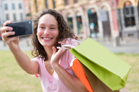 View of a Young attractive woman taking selfie while shoppingの写真素材