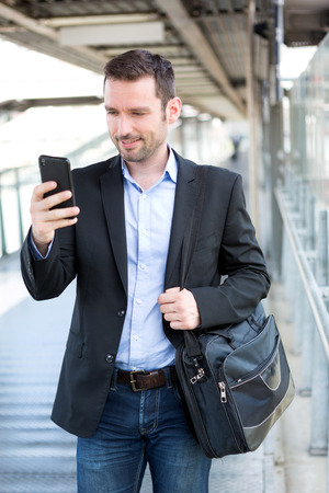 View of a Young attractive business man using smartphoneの写真素材