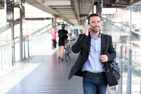 View of a Young attractive business man using smartphoneの写真素材