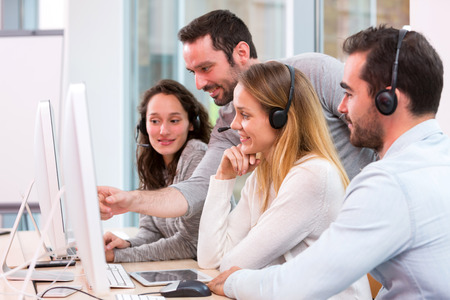 View of a Young attractive people learning their new job at call centerの写真素材