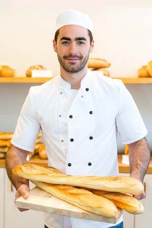 VIew of a Young attarctive baker working at the bakery