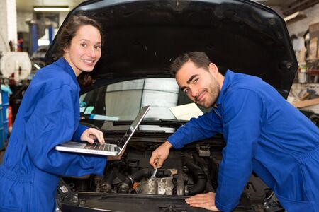 View of a Team of mechanics working at the garageの写真素材