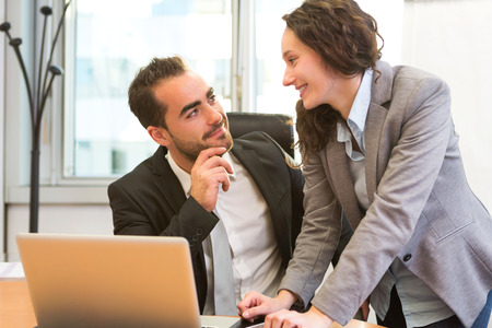 View of a Business man and assistant talking about workの写真素材