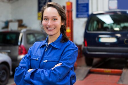 View of a Young attractive woman mechanic working at the garageの写真素材