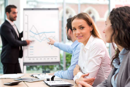 VIew of a Young attractive businesswoman working at the office with associatesの写真素材