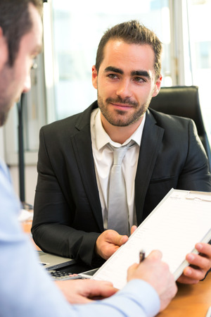 View of a Attractive boss doing interview with his assistantの写真素材