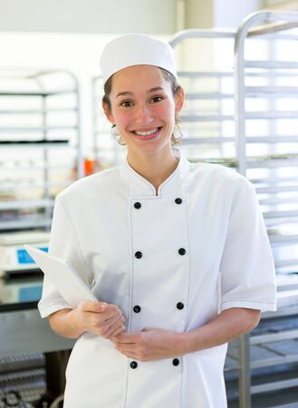 View of an Young attarctive baker working at the bakeryの写真素材