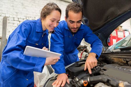 View of a Team of mechanics working at the garageの写真素材