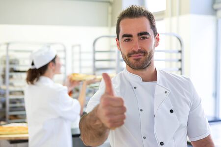 VIew of a Young attarctive baker working at the bakery