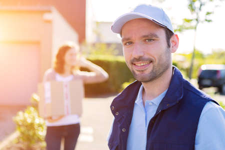View of a Young attractive woman receiving parcel at home