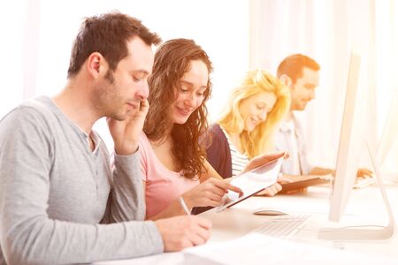 View of a Young attractive people working together at the officeの写真素材