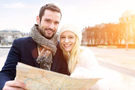 View of a Couple of young attractive tourists watching mapの写真素材