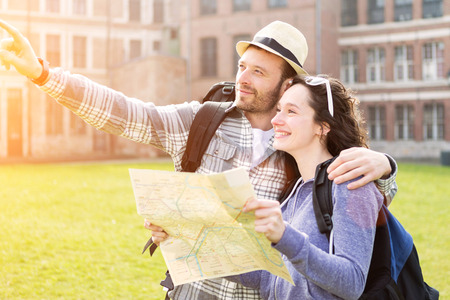 View of a Couple of young attractive tourists watching mapの写真素材