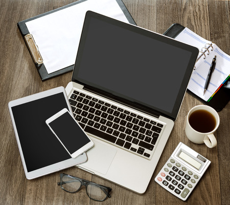 View of a Wood businessman's desk in high definition with laptop, tablet and mobileの写真素材