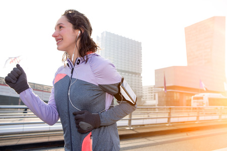 View of a Young attractive woman running downtownの写真素材