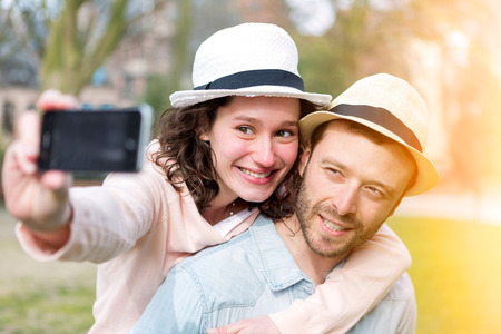 View of a Young couple on holidays taking selfieの写真素材