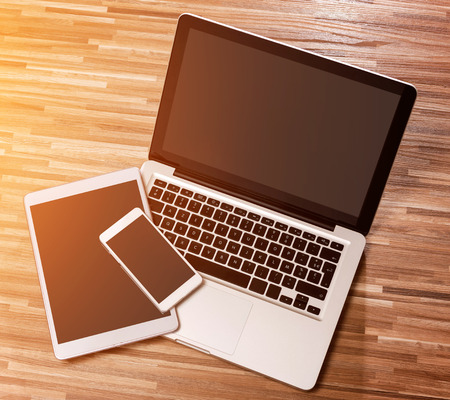 View of a Laptop in high definition with tablet and mobile on a wood backgroundの写真素材