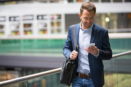 View of a Young attractive business man using smartphoneの写真素材