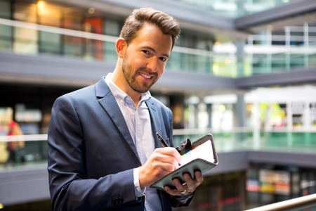 View of a Young attractive man taking a new appointmentの写真素材