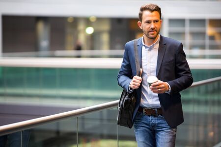 View of a Young attractive business man using smartphoneの写真素材