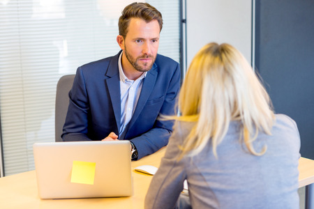 View of a Young attractive employer doing a job interview to a womanの写真素材