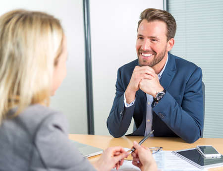View of a Young attractive employer doing a job interview to a womanの写真素材