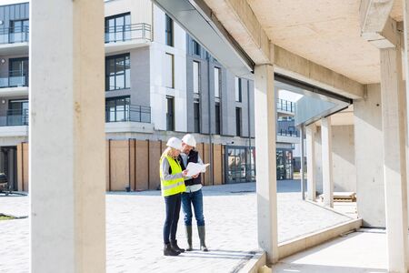 VIew of an Engineer and Architect checking last details on a construction siteの写真素材