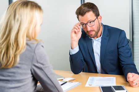 View of a Young attractive employer doing a job interview to a womanの写真素材