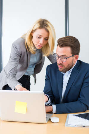 View of a Businessman and his assistant working together at the officeの写真素材