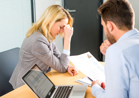 View of a Young attractive woman upset during job interviewの写真素材