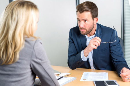 View of a Young attractive employer doing a job interview to a womanの写真素材