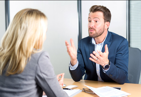 View of a Young attractive employer doing a job interview to a womanの写真素材