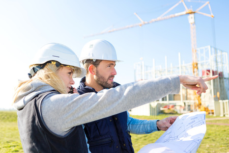 View of Two workers working outside on a construction siteの写真素材
