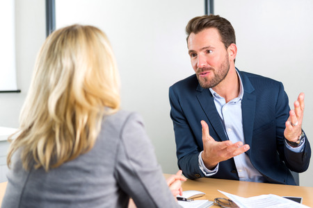 View of a Young attractive employer doing a job interview to a womanの写真素材