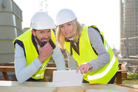 View of 2 Workers on a construction studying blueprintsの写真素材