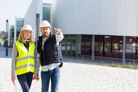 VIew of an Engineer and Architect checking last details on a construction siteの写真素材