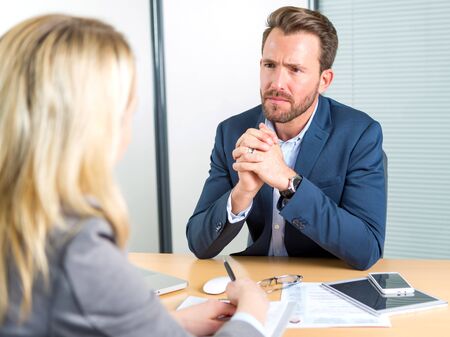 View of a Young attractive employer doing a job interview to a womanの写真素材