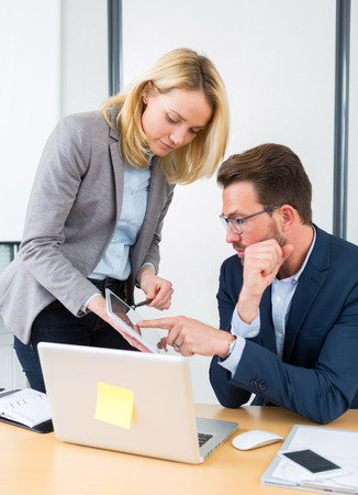 View of a Businessman and his assistant working together at the officeの写真素材