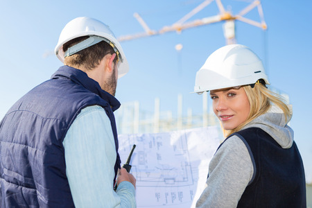 View of Two workers working outside on a construction siteの写真素材
