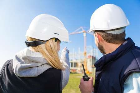 View of Two workers working outside on a construction siteの写真素材