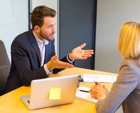 View of a Young attractive employer doing a job interview to a womanの写真素材