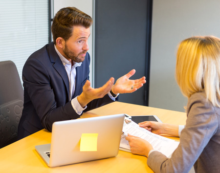 View of a Young attractive employer doing a job interview to a womanの写真素材