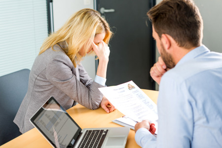 View of a Young attractive woman upset during job interviewの写真素材