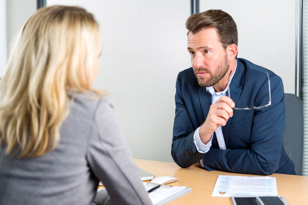 View of a Young attractive employer doing a job interview to a womanの写真素材