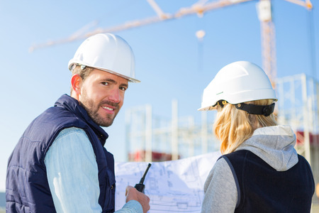 View of Two workers working outside on a construction siteの写真素材