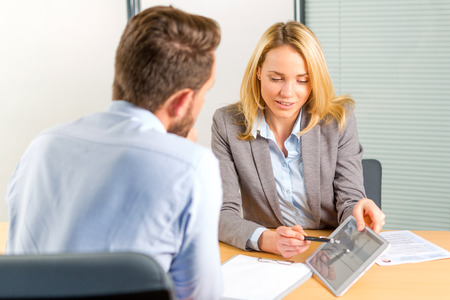 View of a Young attractive woman during job interview using tabletの写真素材